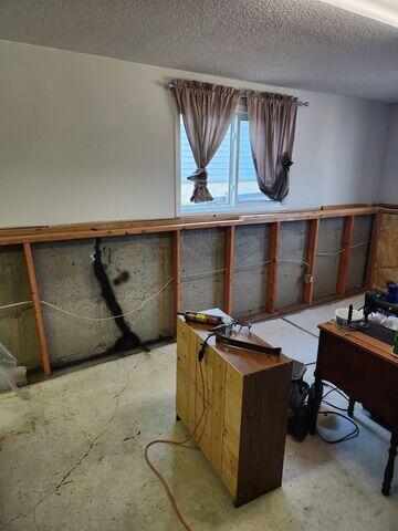 Before: Our Design Specialist, Dylan, recommended securing several waterproofing products throughout the basement.