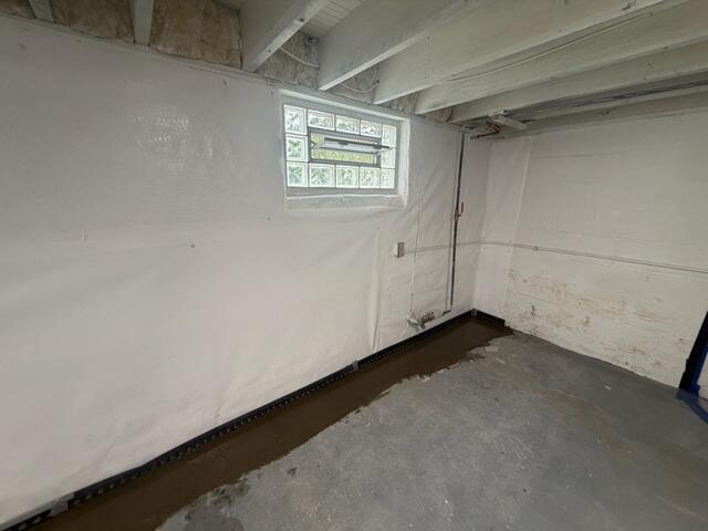 Once installed, the crew re-concretes the floor, leaving a small gap between the floor and the wall to allow moisture to drain into the system and out via the sump pump.