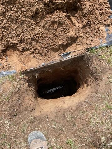 The earth anchor is placed and connected to the interior wall plate. through a small steel pole which runs through the ground