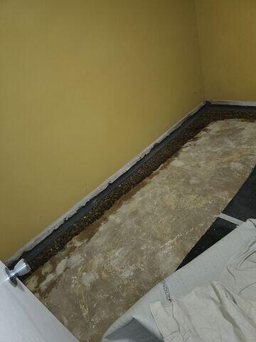 WaterGuard is placed along the edges of the floor and is backfilled with rocks