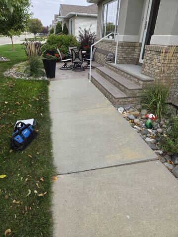 Before: Our Design Specialist, Dylan, recommended lifting and leveling the sidewalk with PolyLevel.