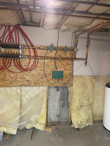 This Eaton Center, New Hampshire, basement would get water leaking via the wall behind the insulation and plywood and along the base of the wall.
