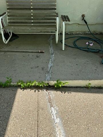 Before: Our Service Technician, Zeke, recommended lifting the damaged patio back to its original level.