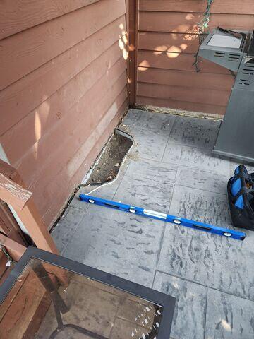 Before: Our Design Specialist, Dylan, recommended lifting and leveling the sidewalk back into place.