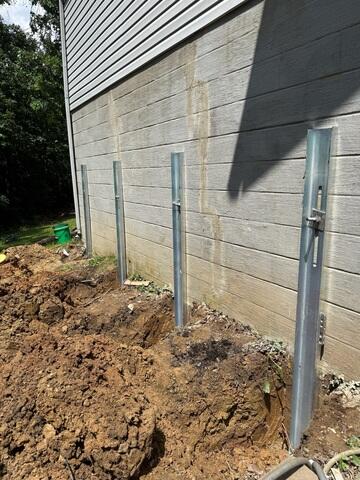 Our crew comes out to install the GeoLock wall anchors, stabilizing the foundation wall.