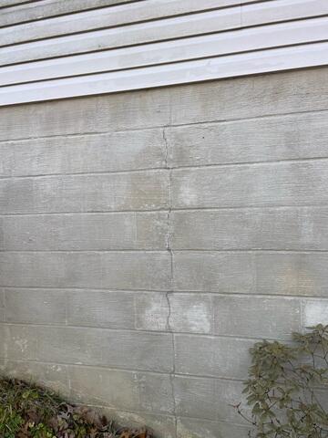 A vertical crack in a block foundation wall such as this one typically indicates outward movement.