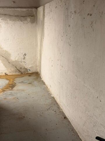 The basement where water leaks could be seen along the floor and through cracks on the walls