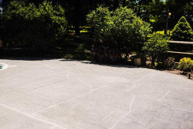 The finished project improved the look and usability of the pool area while helping the homeowner avoid the disruption of a full concrete replacement.