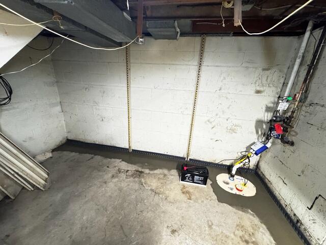 To finish, the crew installs the new TripleSafe sump pump and re-concretes the floors.