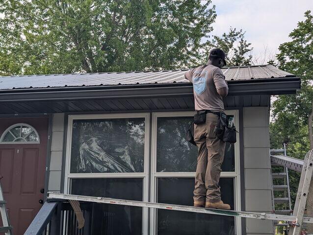 Working on getting the new Gutter Shutter System installed at the proper location to the roof line.