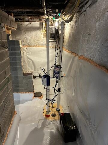 The TripleSafe combines three levels of pumping protection in one sump liner. Its primary and secondary pumps provide dependable everyday and high-volume pumping, while the battery-backup pump can continue removing water during a power outage. 

Closed-cell spray foam was installed in the rim joists and along the upper portion of the basement walls. The foam helps reduce outside-air infiltration and improves insulation in one of the home's most vulnerable areas.