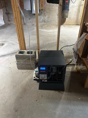 The SaniDry system removes excess moisture from the basement air and automatically maintains the desired humidity level. It is designed specifically for basement and crawl-space environments and operates without requiring the homeowner to empty a collection bucket.