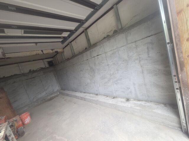Concrete is poured around the steel framework to create a strong, continuous structural wall. Once cured, it becomes the new supporting structure for the affected portion of the home.