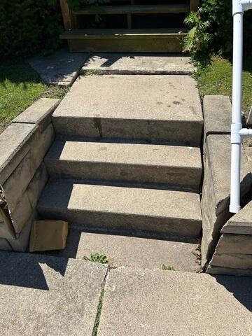 Before: Our Design Specialist recommended lifting the front walkway steps back to their original position.