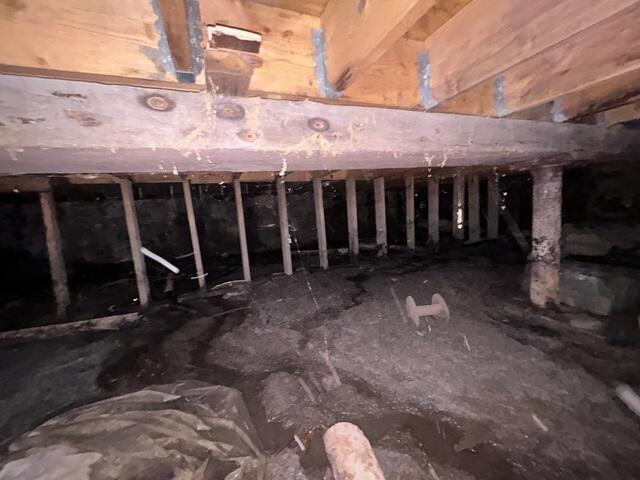 Inadequate support and exposed ground put this crawl space in South Acworth, NH, at risk of structural failure.