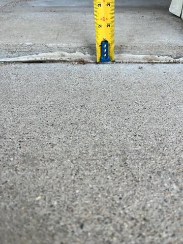 Before: Our Design Specialist, Ian, recommended leveling the sunken driveway slabs back to their original position.