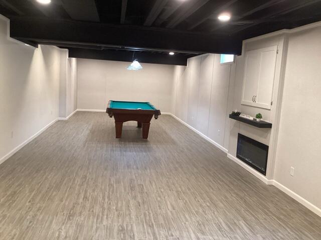 Our crew finished the job with EverLast wall panels and ThermalDry elite plank flooring. The crew also installed the fireplace, cabinet doors over the electrical panel, and a new billiard light fixture.