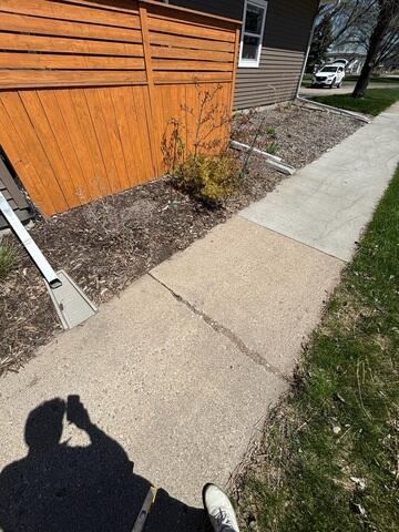 Before: Jackson recommended securing PolyLevel below the damaged sidewalk.