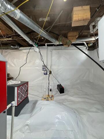 The TripleSafe provides three levels of pumping protection in one sump liner. Its primary and secondary pumps help manage everyday and high-volume water conditions, while the battery-backup pump provides additional protection during a power outage.
CleanSpace was installed across the dirt floor and extended up the foundation walls. The durable liner separates the basement from exposed earth and damp masonry while creating a much cleaner and brighter surface.
