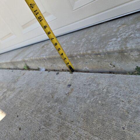 Before: Brad recommended securing PolyLevel below the sinking driveway and walkway.