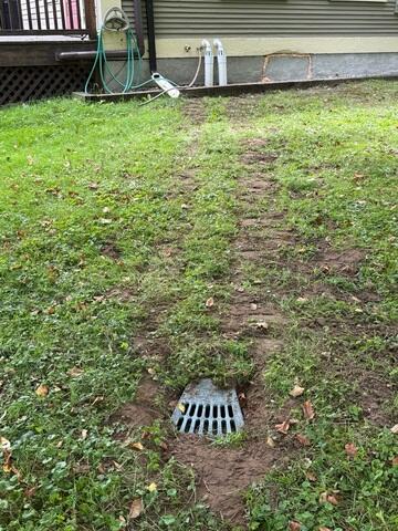 LawnScape™ Outlet provides a discreet termination point for the buried sump discharge line and releases pumped water away from the home's foundation.