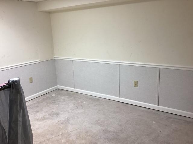 The crew re-finishes the basement walls with our Total Basement Finishing wall panels.