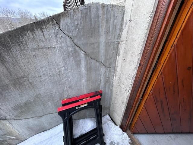 Soil pressure behind a retaining wall placed significant force against the structure, causing cracks and bowing.