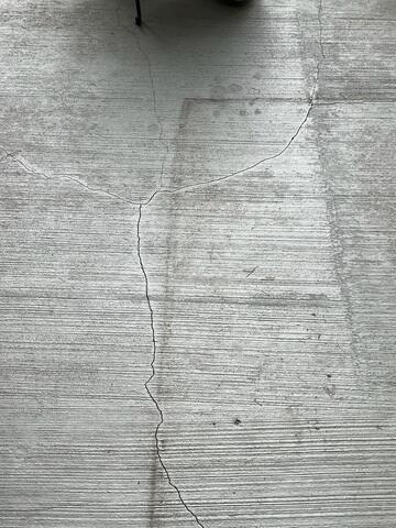 Cracks in the  back porch floor due to a shifting foundation.