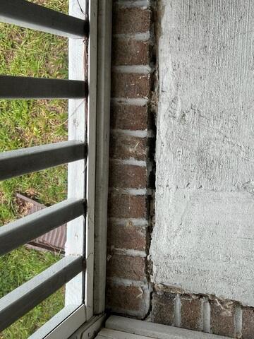 Cracks in the front porch floor due to a shifting foundation.