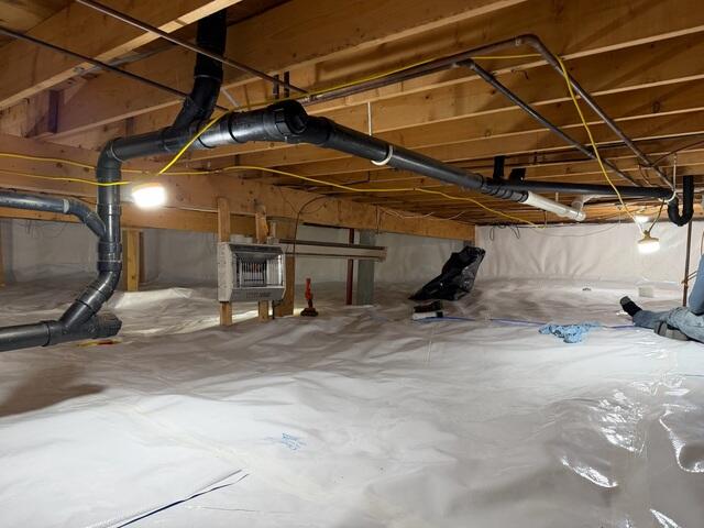 CleanSpace® Crawl Space Encapsulation System - A durable liner designed to isolate the crawl space from ground moisture while providing a clean, bright, and easier-to-maintain environment beneath the home.