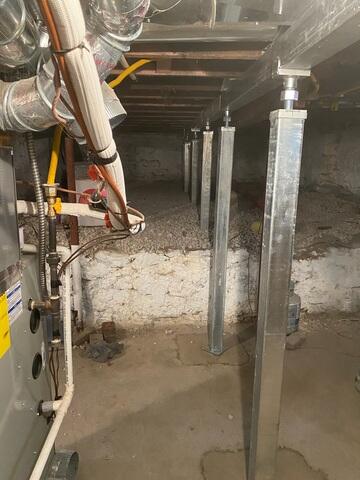 With the SmartJack XT system in place, the steel beams take on some of the weight from the old floor joists, stabilizing the foundation and allowing the sinking floors to be corrected.