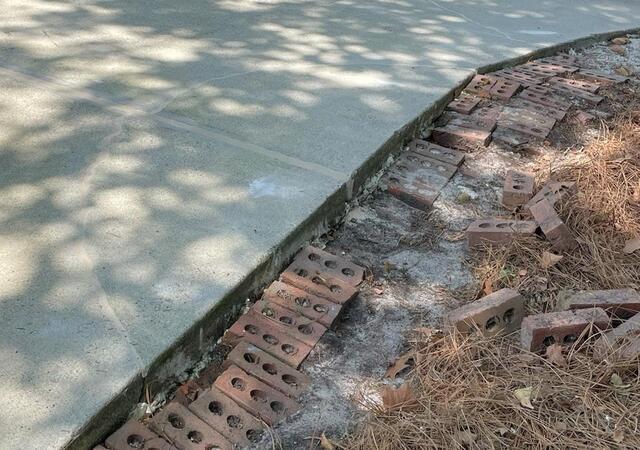 The repaired cracks in the concrete driveway with PolyLevel and NexusPro Crack Repair.