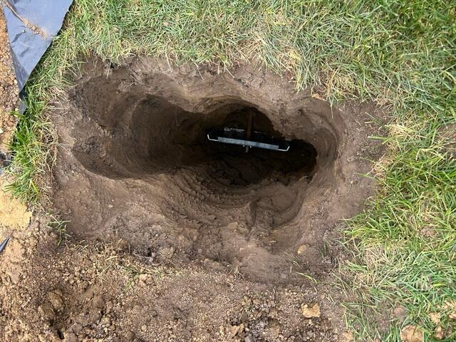 The earth anchor is placed inside the hole that was created and connected to the interior wall plate.