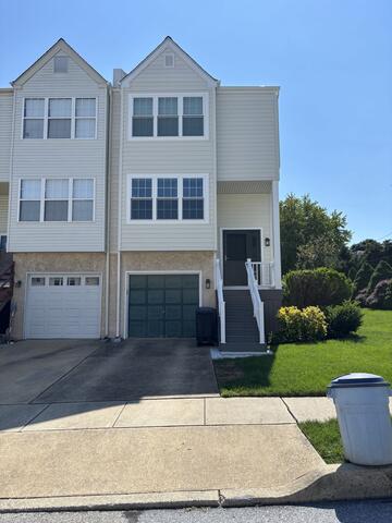 The finished project features Prodigy AZEK 4" siding in Antique Parchment, Okna windows, new front and patio doors, and a rebuilt front porch with TimberTech Edge Prime+ decking in Sea Salt Gray, Radiance Express railing, AZEK-wrapped column, new steps, risers, gutters, and downspouts.