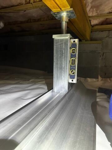 SmartJacks are attached to the floor joists or support beams in the crawl space.
