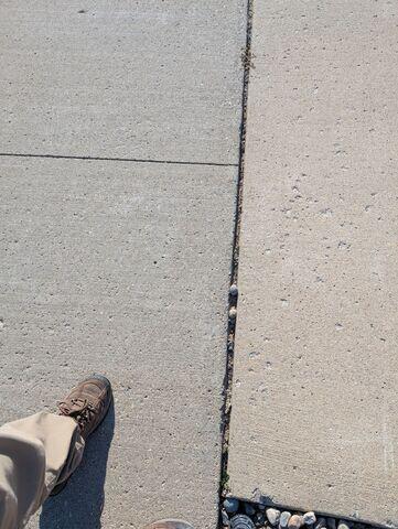 Before: Our Design Specialist, James, traveled to the home to take a closer look at the sinking, damaged driveway.