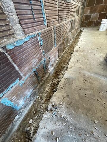 The crew began by drilling a trench along the edges of the concrete floor