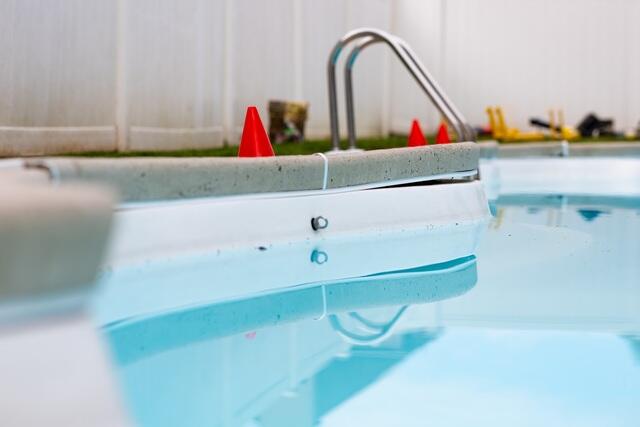 The concrete appeared to be rising up near the pool, leaving a noticeable gap between the deck and the pool area, while the pool liner had also shifted.