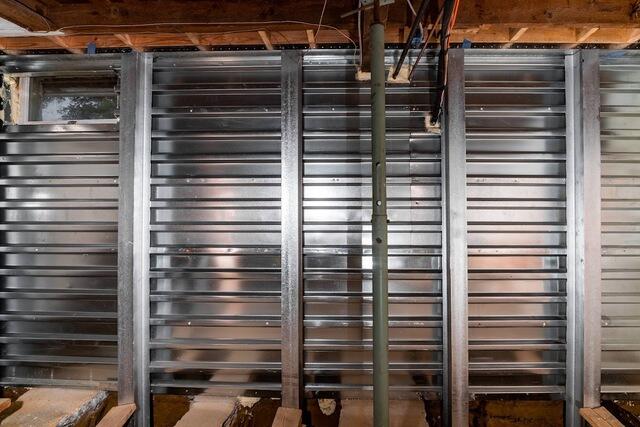With EverBrace installed along the affected walls, the deteriorated brick and block foundation is now covered by a more durable reinforcement system, giving the basement a cleaner and more finished appearance.