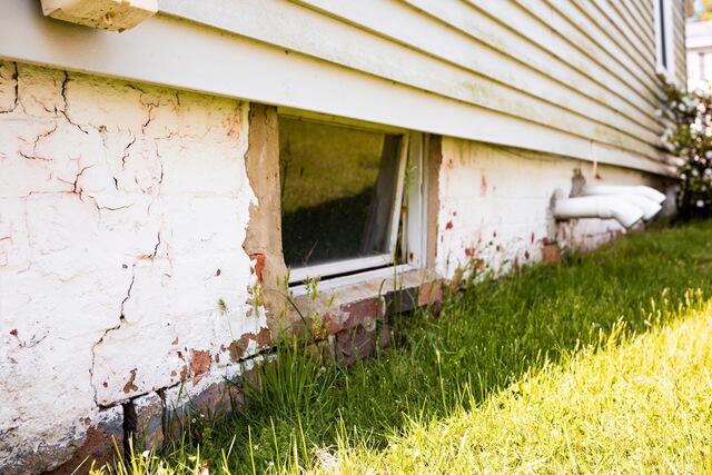 Outside the Wall Township home, a large crack was visible through the brick foundation wall, with loose sections of brick surrounding areas of the damaged masonry.