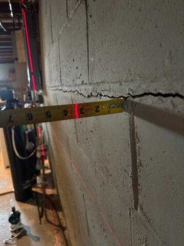 A close-up of the cracked block foundation where our Jackson was measuring how much it had bowed.