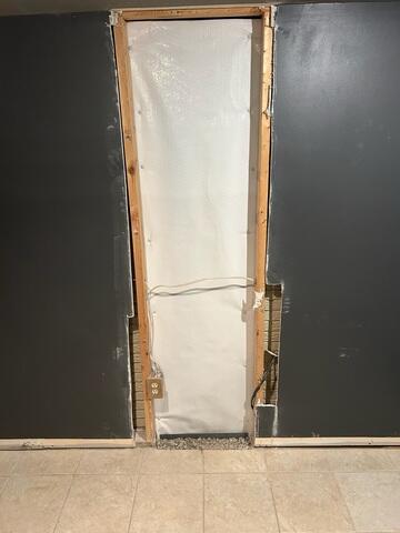 The crew finished the crack repair by covering it with our CleanSpace wall vapor barrier. The next day, our wall restoration crew repaired the drywall.