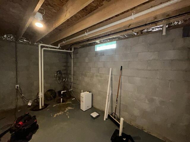 The basement during inspection. The walls were leaking and the sump pump was in need of an upgrade.
