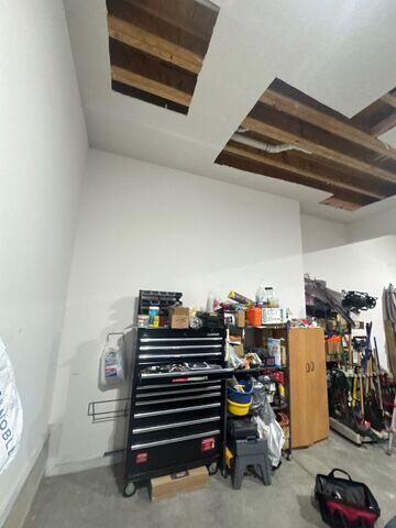 Before: Closer view of the ceiling openings with exposed framing and plumbing above.