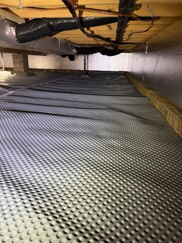 The crew encapsulates the crawl space and insulates the walls with our SilverGlo insulation panels.