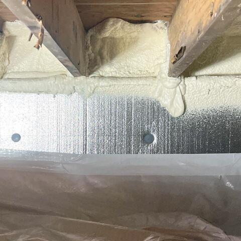 The rim joists and sill plate were spray foamed, rigid foam boards were installed along the cinder block walls, and a durable vapor barrier was laid across the crawl space floor.