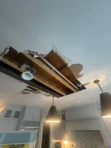 Alternate angle showing the extent of the ceiling opening across the kitchen.