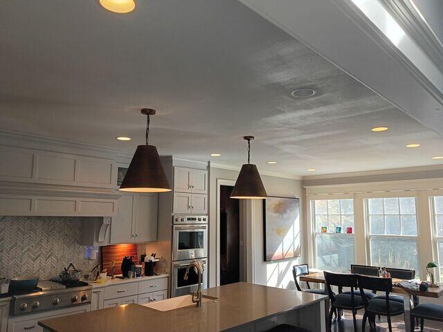 Wide finished view showing the restored ceiling across the kitchen.