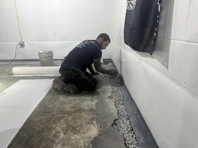 Foreman Anthoni installs WaterGuard along the basement perimeter as part of this waterproofing project. WaterGuard is an interior drainage system designed to collect groundwater entering along the foundation and direct it toward the sump pump for removal. Installing the system around the full perimeter helps provide comprehensive drainage coverage for the basement.