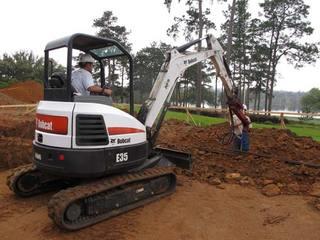 Advancing helical piles